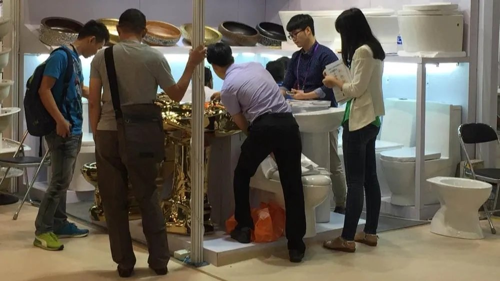 YIDA Sanitary Ware booth at 2015 Canton Fair, displaying golden art basins and ceramic toilets for international buyers