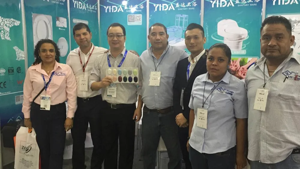 YIDA team with Mexican clients at 2016 Mexico Expo, showcasing color swatches for sanitary ware customization
